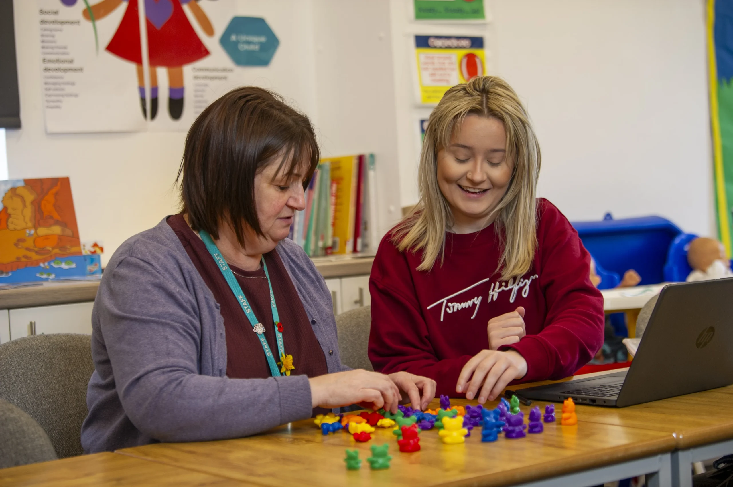 Student and teacher looking at children toys
