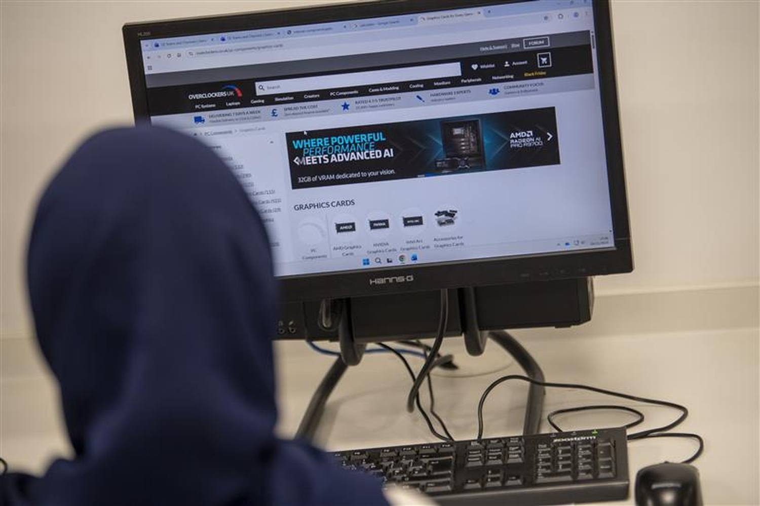 Person in hoodie using computer with Graphics